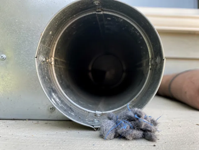 San Juan Capistrano Dryer Vent Cleaning technician using specialized equipment to clear severe dryer vent blockage in San Juan Capistrano